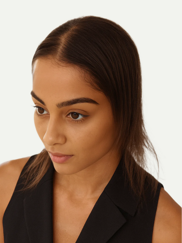 Woman wearing a black sleeveless blazer against a white background