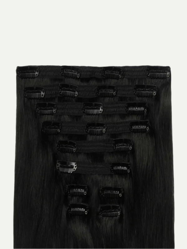Set of black hair extensions with clips on a white background