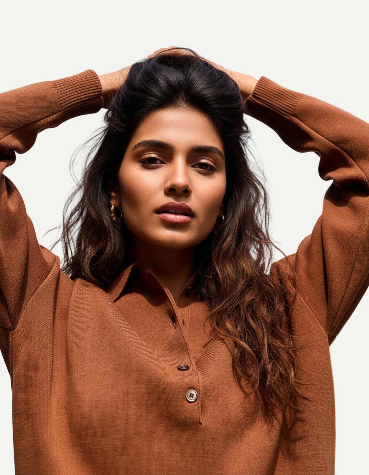 Woman wearing a brown sweater with a blurred background